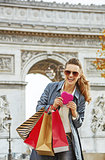 woman with shopping bags near Arc de Triomphe in Paris, France