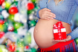 Pregnant woman with Christmas gift