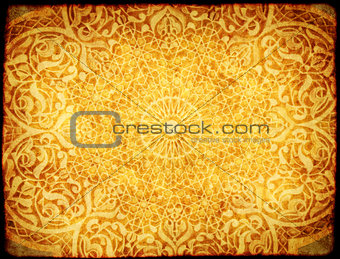 Grunge background with paper texture and floral ornament in Moro