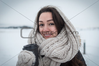 Woman with hot coffee on a cold day
