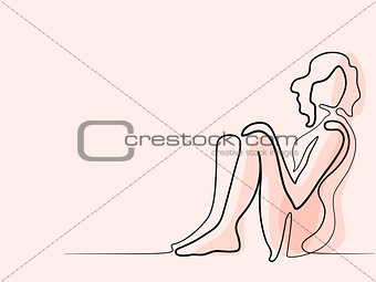 Woman sitting by the wall
