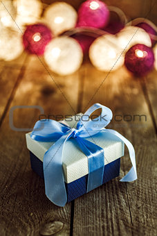 Christmas background with decorations and gift box on wooden boa