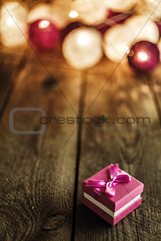 Christmas background with decorations and gift box on wooden boa