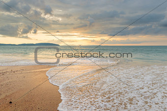 sea surf on a sandy beach in Thailand with a beautiful sky over 