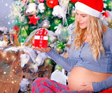 Pregnant woman with Christmas gift 