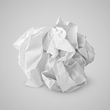 Crumpled paper ball on gray