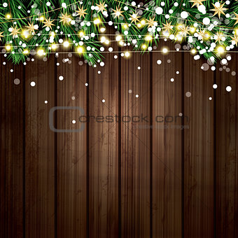 Fir Branch with Neon Lights and Snowflakes on Wooden Background.