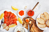 Delicious lunch with salted salmon, red caviar, fresh bread and 