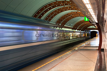 Subway station. Diagonal blue motion blur metro train background. Train departure. Fast underground subway train while hurtling fast with commuters on board.