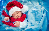 Cute baby boy sleeping in Santa hat