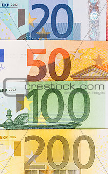 Background from different euro banknotes close up.