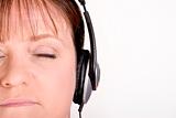 Older female listening to music on headphones