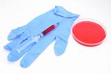syringe over blue gloves