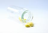 A glass bottle of yellow meds