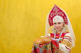 Russian woman in a folk russian dress Holds a bread