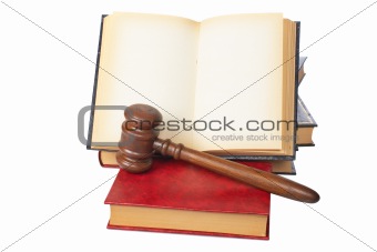 Wooden gavel and old opened law book