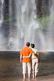 Couple contemplating a waterfall