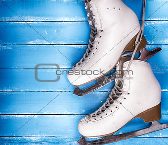 a pair of worn white leather skates for figure skating 