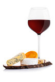 Glass of red wine with cheese selection and grapes