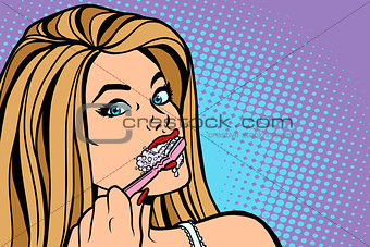 woman brushing her teeth with a toothbrush