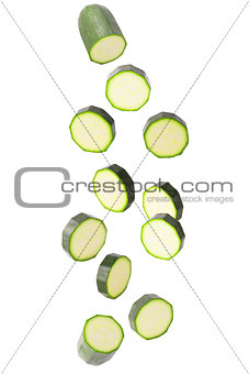 Falling courgettes isolated on white
