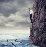 Businessman is likely to fall into the sea with shark. Risks and difficulties concept