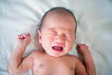 Asian newborn baby boy crying