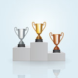 Pedestal with the cup winner of the first Gold , the second Silver and the third Bronze place on white background. Vector Illustration