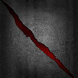 Grunge metal background with red texture showing through the cra