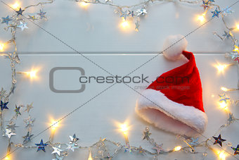 Red Santa Claus hat and garland isolated .