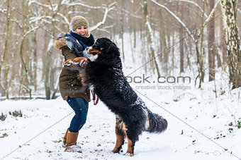 Dog hugging his mom on a winter day with snow