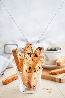 Italian cranberry almond biscotti  and cup of coffee on backgrou