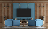 Home cinema room with TV hanging on blue wall