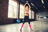 Blonde girl working out at the gym with a kettlebell