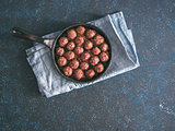 Homemade beef meatballs in cast-iron skillet
