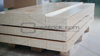 Stack of wood particleboard panels on the warehouse or factory