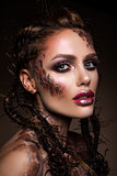 Fashion model with bright makeup and colorful glitter