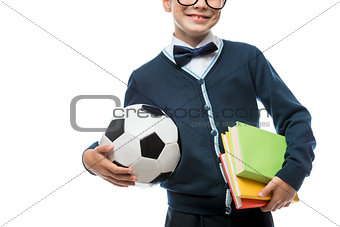close-up of schoolboy's hand with ball and textbooks, schoolboy 