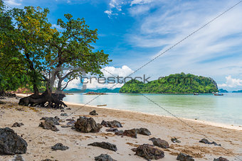 sandy shore with large stones on the sand and beautiful sea view