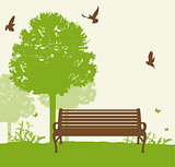 Bench under a green tree