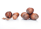 Raw hazelnuts with shell on white background