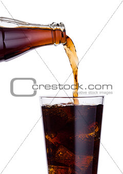 Pouring cola soda drink from bottle to glass 
