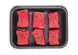 Pieces of fresh raw beef meat in plastic tray