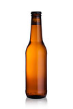 Brown glass beer bottle with black cap isolated