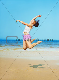 Woman jumping on the beach 