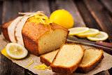 Classic lemon pound cake on rustic wooden background 