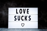 text love sucks in a lightbox