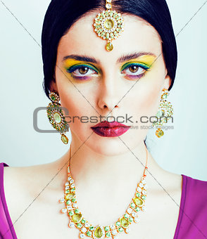 young pretty caucasian woman like indian in ethnic jewelry close