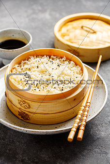 Steamed rice in bamboo steamer