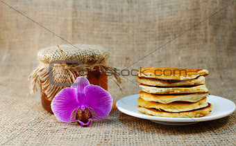 Fried pancakes are a mountain on a plate of sweets 